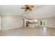 Open floor plan with tile flooring flows from the living area into a modern kitchen with a center island at 13116 Marathon Blvd, Port Charlotte, FL 33981