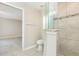 Modern main bathroom with tiled walk-in shower and glass partition, plus private toilet area at 13116 Marathon Blvd, Port Charlotte, FL 33981