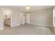 Bright main bedroom showcasing tile flooring, neutral walls, and an attached bathroom for added convenience at 13116 Marathon Blvd, Port Charlotte, FL 33981