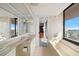 Bright bathroom with a soaking tub, shower, vanity, and a large window with views at 1340 Gulf Blvd # 12A, Clearwater Beach, FL 33767