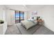 Bright bedroom with a neutral palette, balcony access, and contemporary furnishings at 1340 Gulf Blvd # 12A, Clearwater Beach, FL 33767