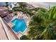 Overhead view of a community pool and hot tub area surrounded by palm trees and lounge chairs at 1340 Gulf Blvd # 12A, Clearwater Beach, FL 33767