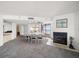 Open-concept dining room with white furniture, fireplace, and ocean views from the balcony door at 1340 Gulf Blvd # 12A, Clearwater Beach, FL 33767