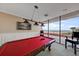 Game room featuring a pool table with views of the ocean and balcony access at 1340 Gulf Blvd # 12A, Clearwater Beach, FL 33767