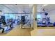 Bright gym with exercise equipment featuring large windows with beach views and ceiling fans at 1340 Gulf Blvd # 12A, Clearwater Beach, FL 33767