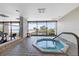 Indoor hot tub in a bright room with big windows overlooking beach, ocean and palm trees at 1340 Gulf Blvd # 12A, Clearwater Beach, FL 33767