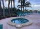 Community hot tub surrounded by lounge chairs, landscaping, and convenient beach access at 1340 Gulf Blvd # 12A, Clearwater Beach, FL 33767
