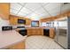 Bright kitchen features wooden cabinets, modern appliances, and light countertops at 1340 Gulf Blvd # 12A, Clearwater Beach, FL 33767