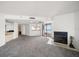 Open-concept living room with fireplace, wet bar, and balcony with expansive water views at 1340 Gulf Blvd # 12A, Clearwater Beach, FL 33767