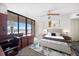 Light and airy bedroom with a large desk, king sized bed, and a sliding glass door to the lanai at 1340 Gulf Blvd # 12A, Clearwater Beach, FL 33767