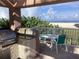 Outdoor kitchen and dining area on patio with ocean views and white picket fence at 1340 Gulf Blvd # 12A, Clearwater Beach, FL 33767
