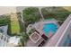 Aerial view of the community pool and hot tub surrounded by lounge chairs, landscaping, and beach access at 1340 Gulf Blvd # 12A, Clearwater Beach, FL 33767