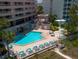 Community pool, lounge chairs, and a hot tub are all part of the amenities in this community at 1340 Gulf Blvd # 12A, Clearwater Beach, FL 33767