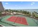 Aerial view of tennis court with surrounding landscapes, buildings, and water views at 1340 Gulf Blvd # 12A, Clearwater Beach, FL 33767