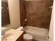 Bathroom featuring a single sink vanity, toilet and shower/tub combo with tan tile surround at 1353 El Pardo Dr, Trinity, FL 34655