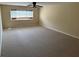 Spacious bedroom featuring neutral walls, carpet, ceiling fan and a window with view of exterior at 1353 El Pardo Dr, Trinity, FL 34655