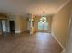 Formal dining room with tiled flooring, a modern chandelier, and a view into the home entrance at 1353 El Pardo Dr, Trinity, FL 34655