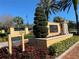 Champions Club entrance sign with lush landscaping, palm trees, and manicured greenery at 1353 El Pardo Dr, Trinity, FL 34655