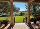 Scenic view from covered patio overlooking lush landscaping, a golf course, and a serene lake at 1353 El Pardo Dr, Trinity, FL 34655