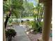 Lush front yard with tropical plants, flowerbeds, and a view of the street from the porch at 1353 El Pardo Dr, Trinity, FL 34655