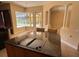 Eat-in kitchen area with granite countertops, cooking island, and views of the pool area at 1353 El Pardo Dr, Trinity, FL 34655