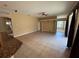 Open living room with tiled flooring, ceiling fan, and a view of the kitchen and lanai at 1353 El Pardo Dr, Trinity, FL 34655