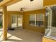 Enclosed patio with tile floor, ceiling fan, and sliding glass doors, ideal for outdoor relaxation at 1353 El Pardo Dr, Trinity, FL 34655