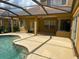 Screened-in patio featuring a pool and plenty of space for lounging and entertaining at 1353 El Pardo Dr, Trinity, FL 34655