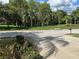 View of the neighborhood street with mature trees and lush landscaping from the property at 1353 El Pardo Dr, Trinity, FL 34655