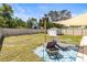 Spacious backyard with privacy fence, shed, lounge chairs and patio area for relaxing outdoors at 1406 Nebraska Ave, Palm Harbor, FL 34683