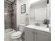 Modern bathroom featuring a shower over tub, white vanity, and contemporary finishes at 1406 Nebraska Ave, Palm Harbor, FL 34683