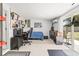 Bedroom with tile floors, neutral walls, dresser, desk, and sliding glass door to the backyard at 1406 Nebraska Ave, Palm Harbor, FL 34683