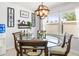 Bright dining area featuring a modern light fixture, stylish decor, and a round table perfect for intimate meals at 1406 Nebraska Ave, Palm Harbor, FL 34683