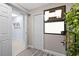 Hallway featuring a plant and coat rack, leading to other rooms in the home at 1406 Nebraska Ave, Palm Harbor, FL 34683