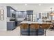 Stylish kitchen featuring gray cabinets, stainless steel appliances, and a large island with seating at 1406 Nebraska Ave, Palm Harbor, FL 34683