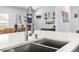 Close-up of the kitchen sink featuring stainless-steel appliances and fixtures and a bright, airy atmosphere at 1406 Nebraska Ave, Palm Harbor, FL 34683