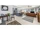 Open-concept living space with modern kitchen, stylish furniture, and neutral decor for versatile living at 1406 Nebraska Ave, Palm Harbor, FL 34683