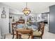 Open concept living space featuring a dining area, comfortable seating, and a modern kitchen with gray cabinets at 1406 Nebraska Ave, Palm Harbor, FL 34683