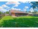 Lush green backyard with a screened lanai, great for relaxation and outdoor enjoyment at 1604 Dusty Rose Ln, Brandon, FL 33510