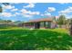 Large grassy backyard with a screened-in patio, perfect for outdoor activities at 1604 Dusty Rose Ln, Brandon, FL 33510