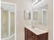 Bright bathroom featuring updated fixtures, tile floors, a shower with glass doors and updated vanity at 1604 Dusty Rose Ln, Brandon, FL 33510