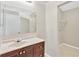 Neutral bathroom featuring a modern vanity with drawers, large mirror and access to a walk-in closet at 1604 Dusty Rose Ln, Brandon, FL 33510