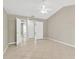 Spacious bedroom featuring a ceiling fan and multiple closets with easy access to the bathroom at 1604 Dusty Rose Ln, Brandon, FL 33510