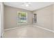Sunlit bedroom with neutral walls, a ceiling fan, tile flooring, and bright windows at 1604 Dusty Rose Ln, Brandon, FL 33510