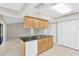 Kitchen with granite countertop island, light wood cabinets, updated appliances and easy access to the living room at 1604 Dusty Rose Ln, Brandon, FL 33510