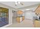 Bright open kitchen with wooden cabinetry, white appliances, and an eat-in area at 1604 Dusty Rose Ln, Brandon, FL 33510