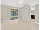 Open concept living room featuring large windows with backyard views and access to an adjacent bathroom at 1604 Dusty Rose Ln, Brandon, FL 33510