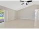 Open living room offering neutral paint colors, sliding doors to a patio and an adjoining bedroom at 1604 Dusty Rose Ln, Brandon, FL 33510