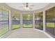 Charming sunroom featuring large windows with views of the backyard and a ceiling fan at 1604 Dusty Rose Ln, Brandon, FL 33510