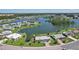 Expansive aerial view showcasing waterfront homes on a serene lake in a well-maintained community at 1717 Danbury Dr, Sun City Center, FL 33573